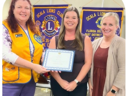 Ocala Lions with Brittany Cecil of Lotus Marion, holding certificates